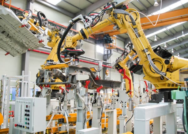 An automated robotic arm operating in an automotive factory.